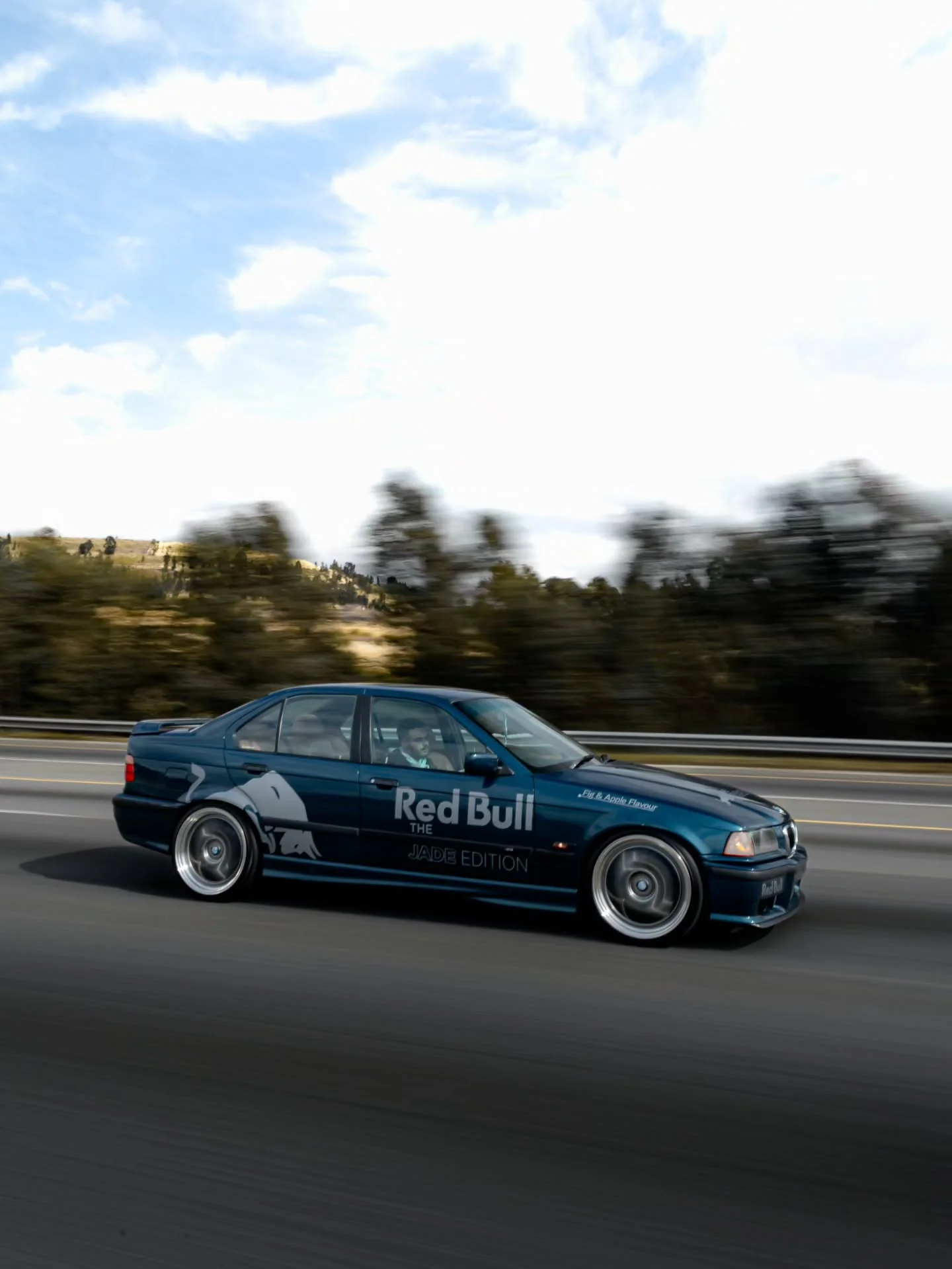 Blue BMW photographed on a drive