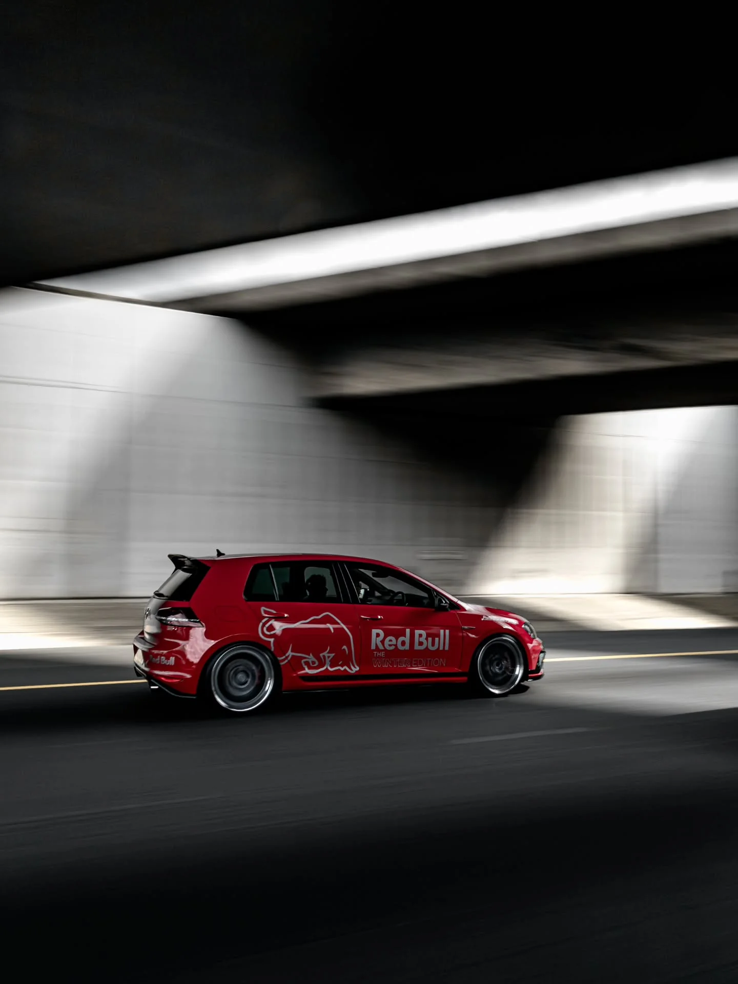 Red performance hatchback photographed on the road