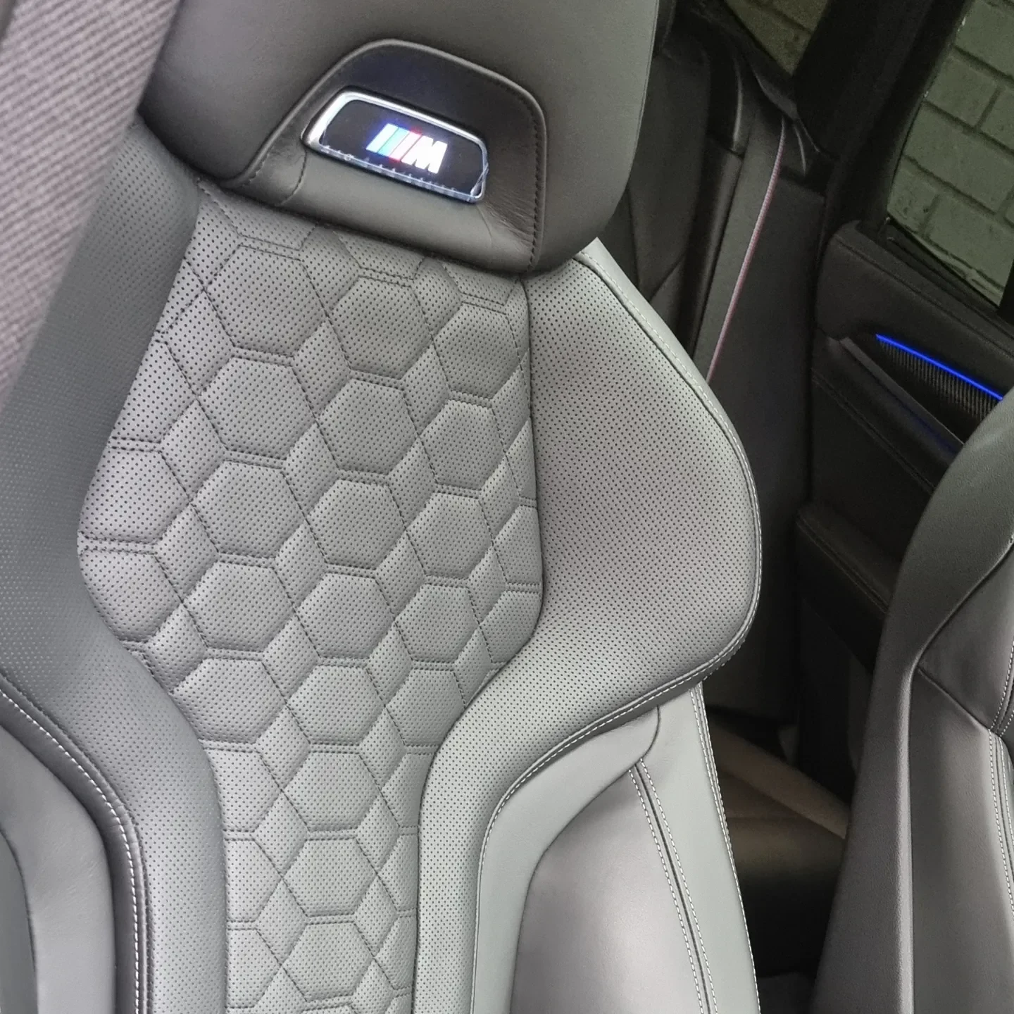Perforated leather seat with honeycomb stitching in a BMW