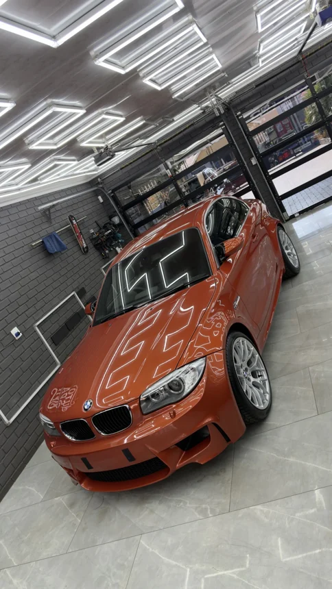 Orange BMW coupe in the Auto Spa studio