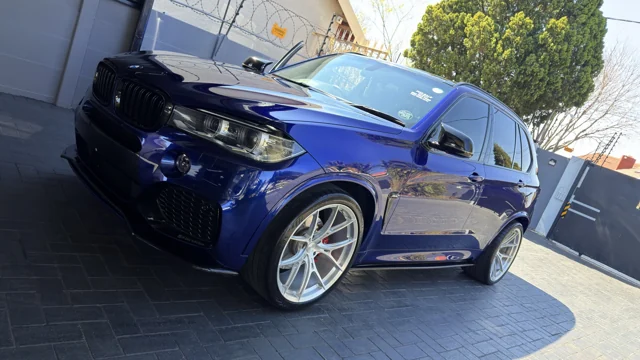 Blue BMW SUV photographed outdoors