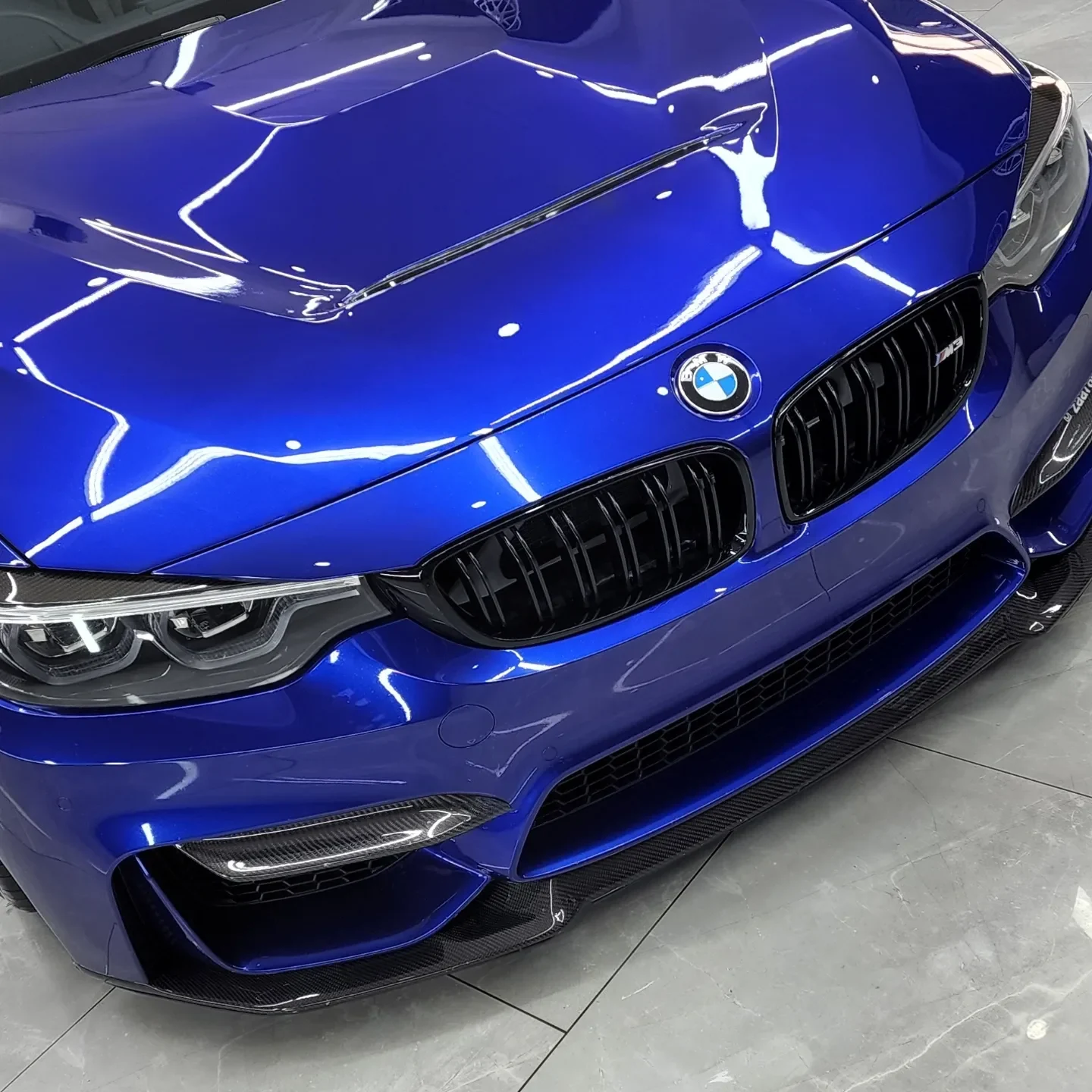 Rich blue BMW paint reflecting the studio lights